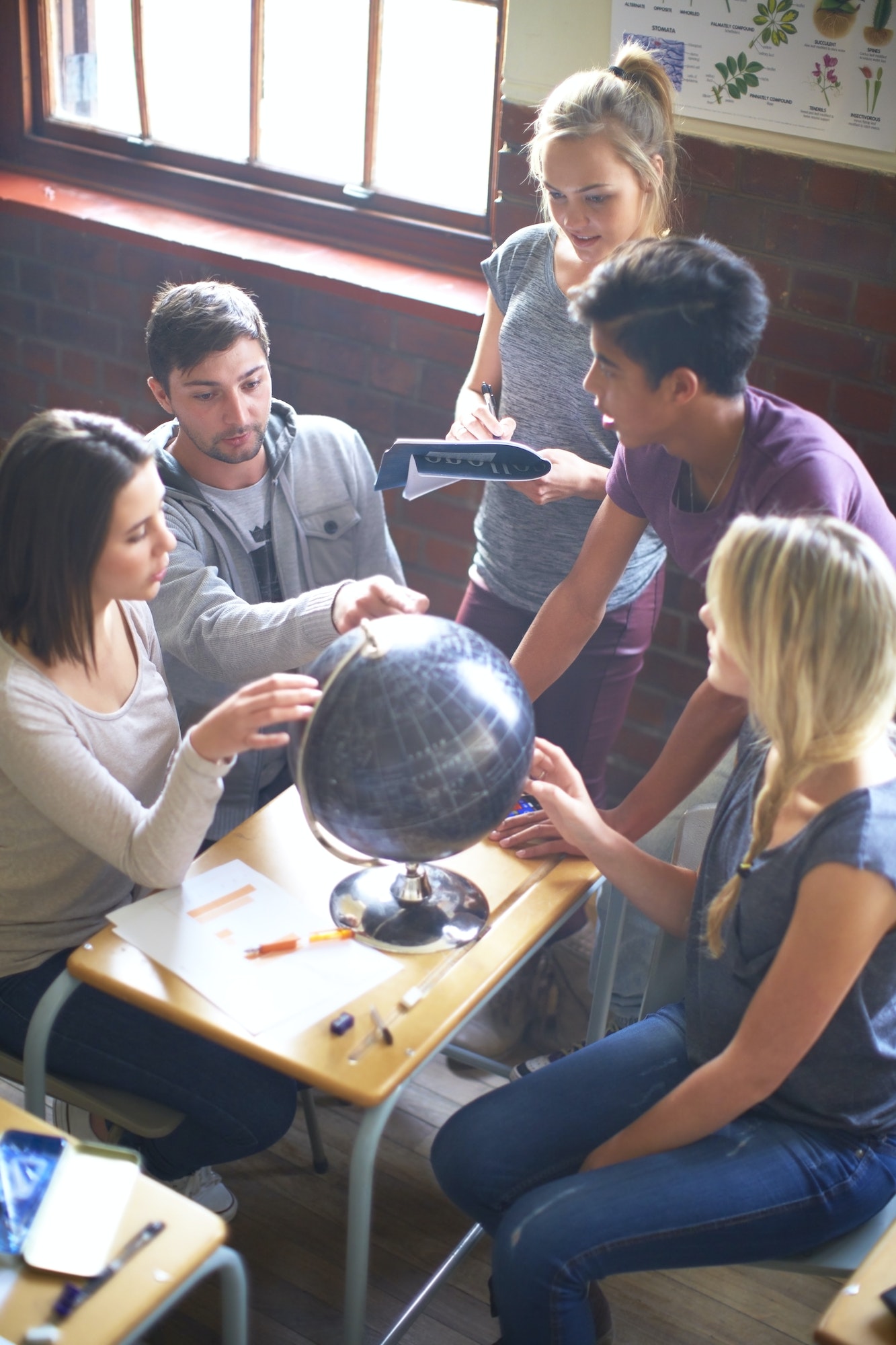Students in classroom with globe