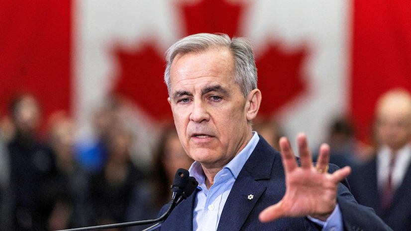 Canadian government official addressing immigration policy updates in front of a Canadian flag backdrop.