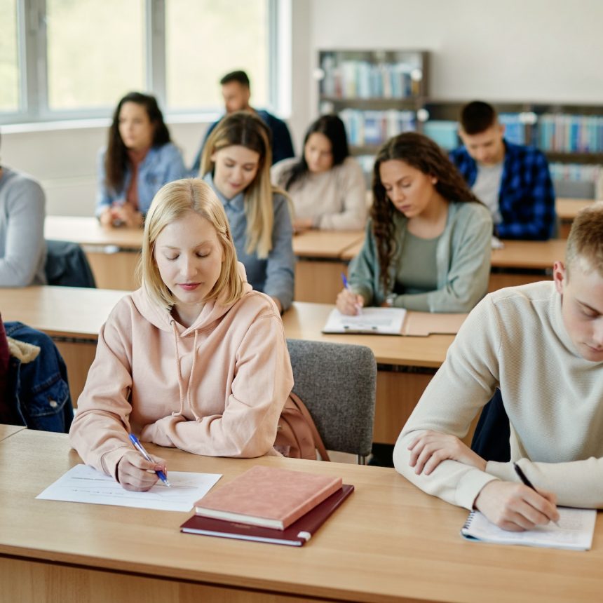Group of students writing an exam during a class at the university.